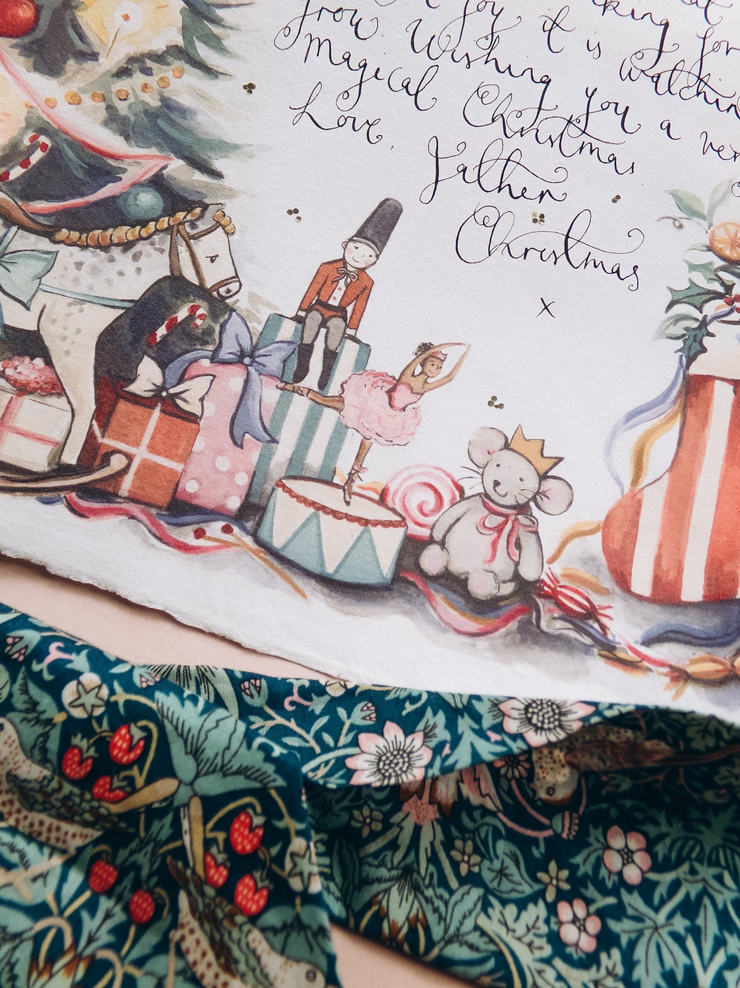 Illustrated Christmas scene with toys and text on a decorative fabric background