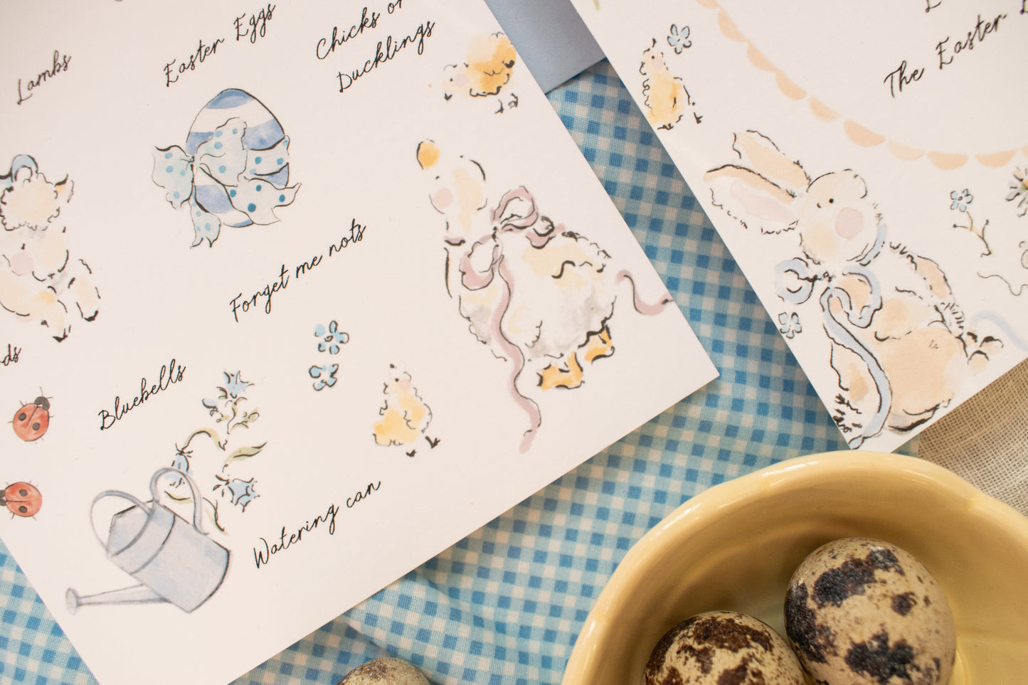 Illustrated Easter cards with animals on a checkered tablecloth.