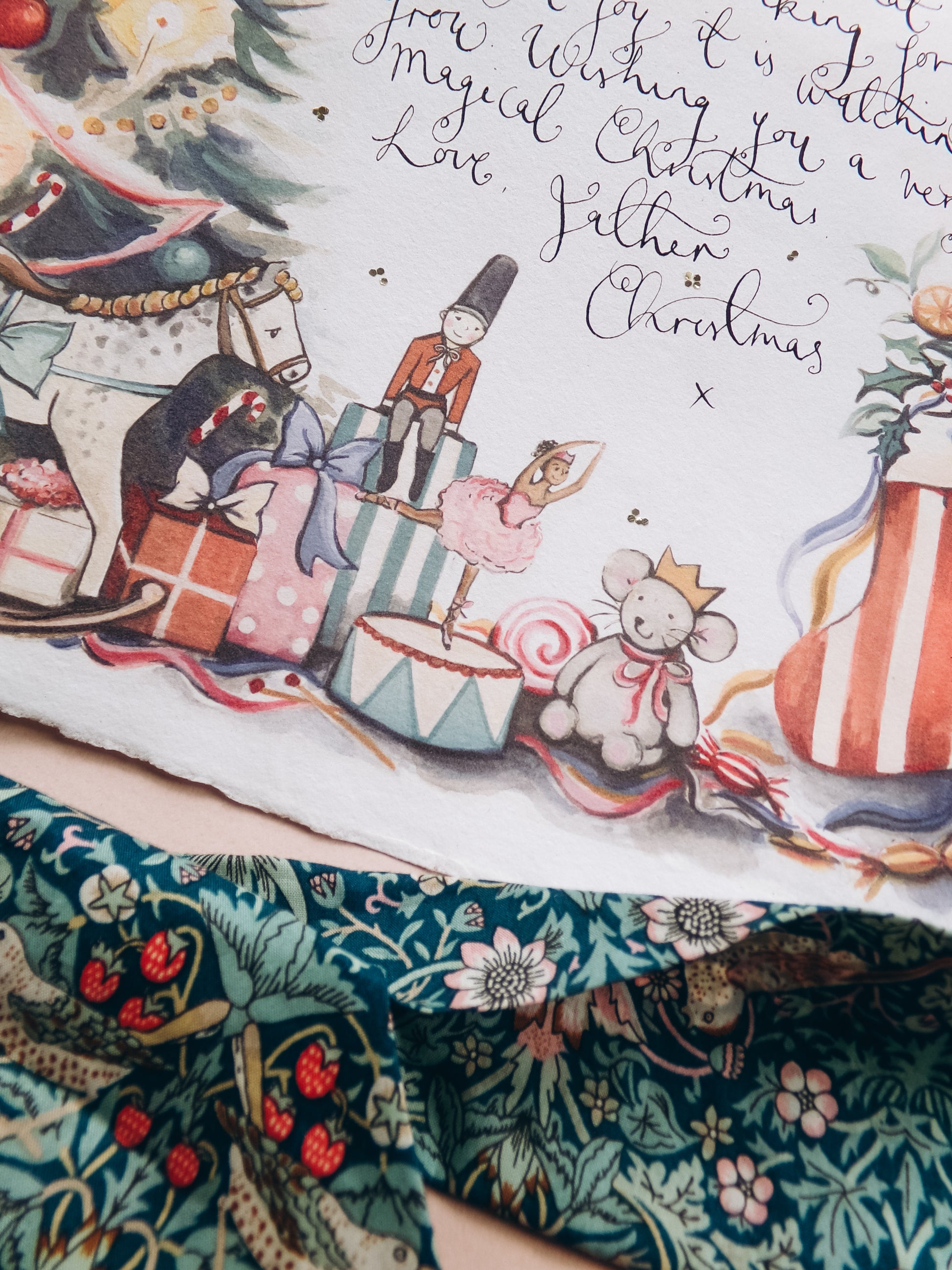 Illustrated Christmas scene with toys and text on a decorative fabric background