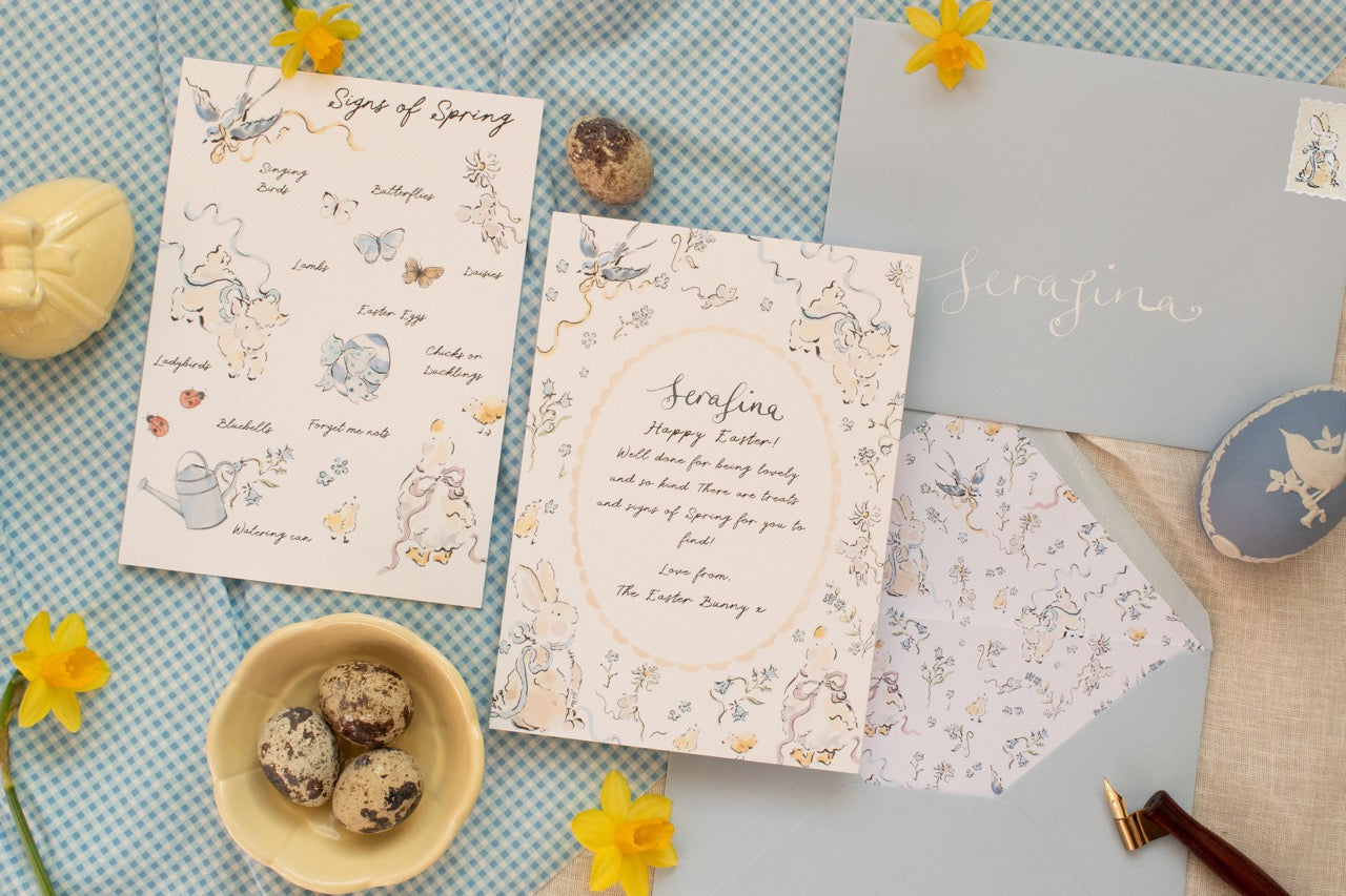 Stationery items including cards and envelopes on a textured surface with decorative elements.