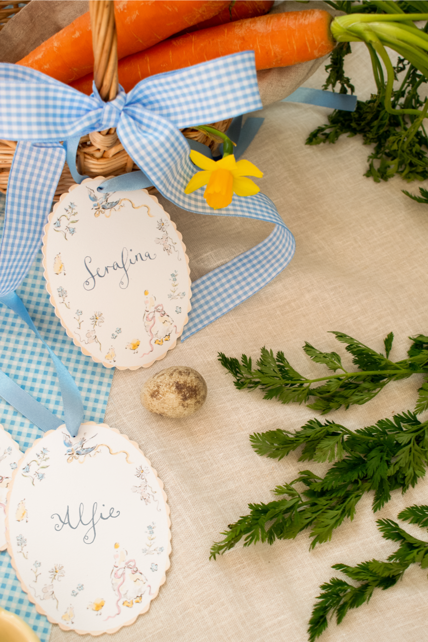 Decorative Easter eggs with blue ribbons and carrots on a textured surface.