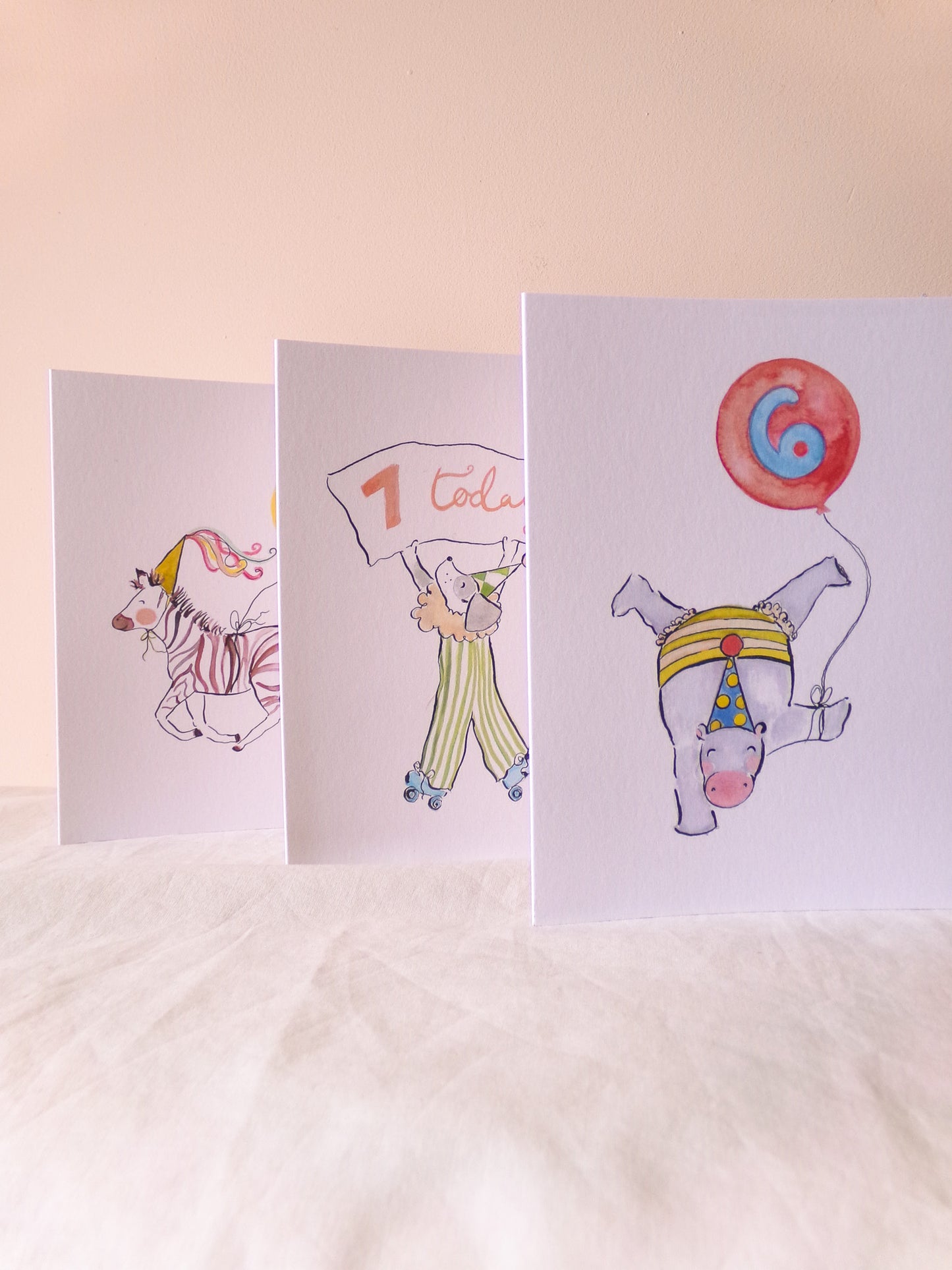 Three children's birthday cards with cartoon characters on a light background