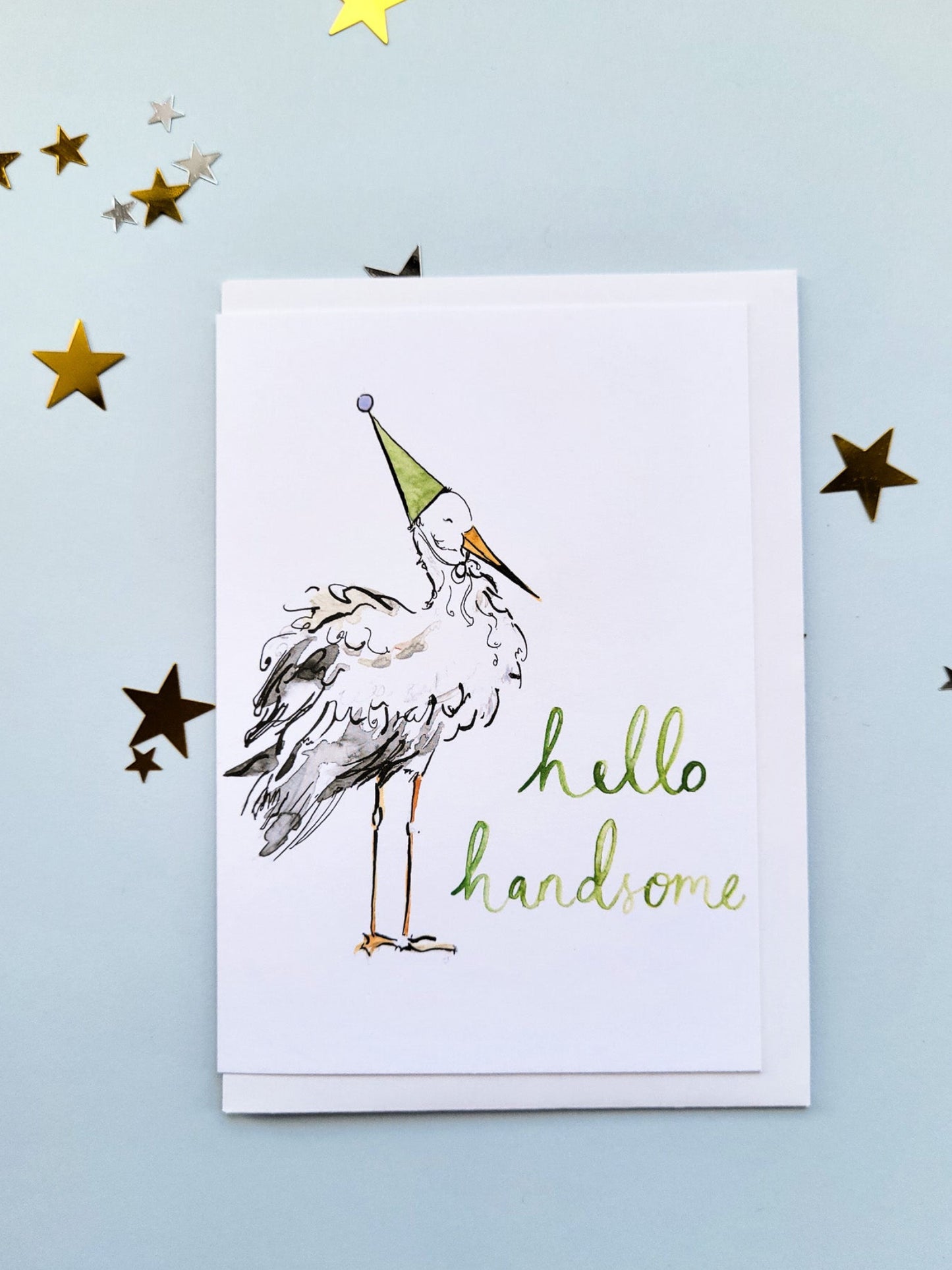 Card with a stork illustration and 'hello handsome' text on a blue background with star decorations.