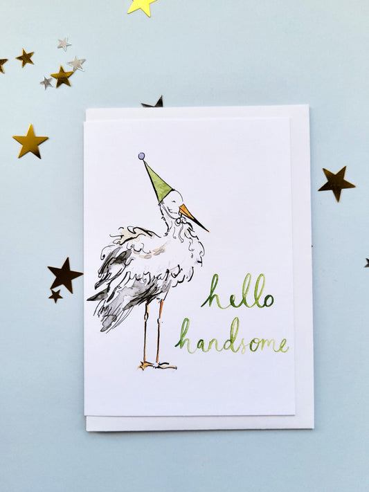 Card with a stork illustration and 'hello handsome' text on a blue background with star decorations.