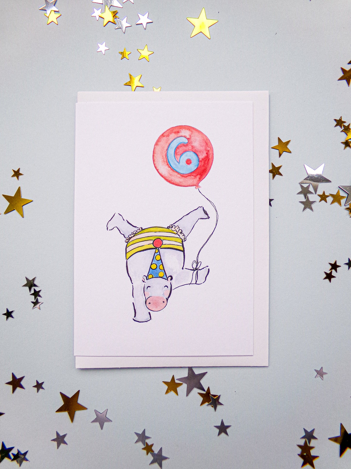 Illustration of a hippo with a party hat and balloon on a star-patterned background