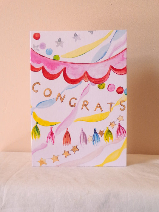 Colorful 'Congrats' card on a beige background