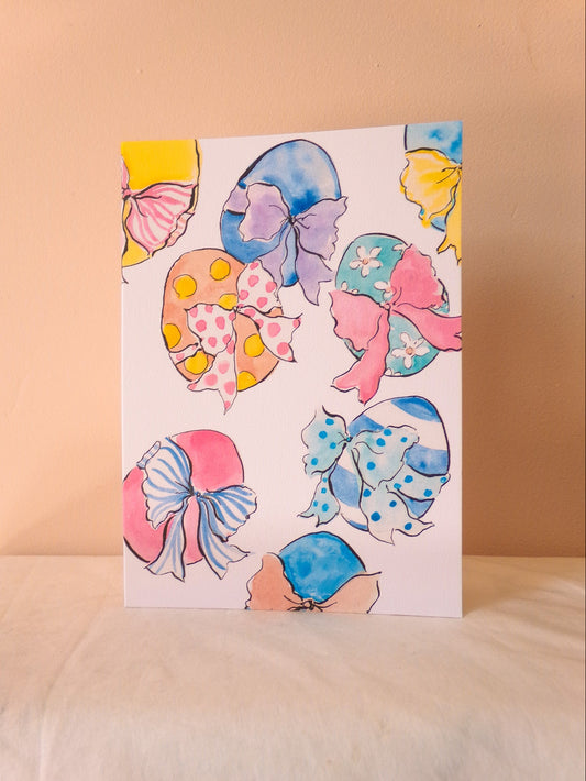 Card with colorful bow designs on a beige background