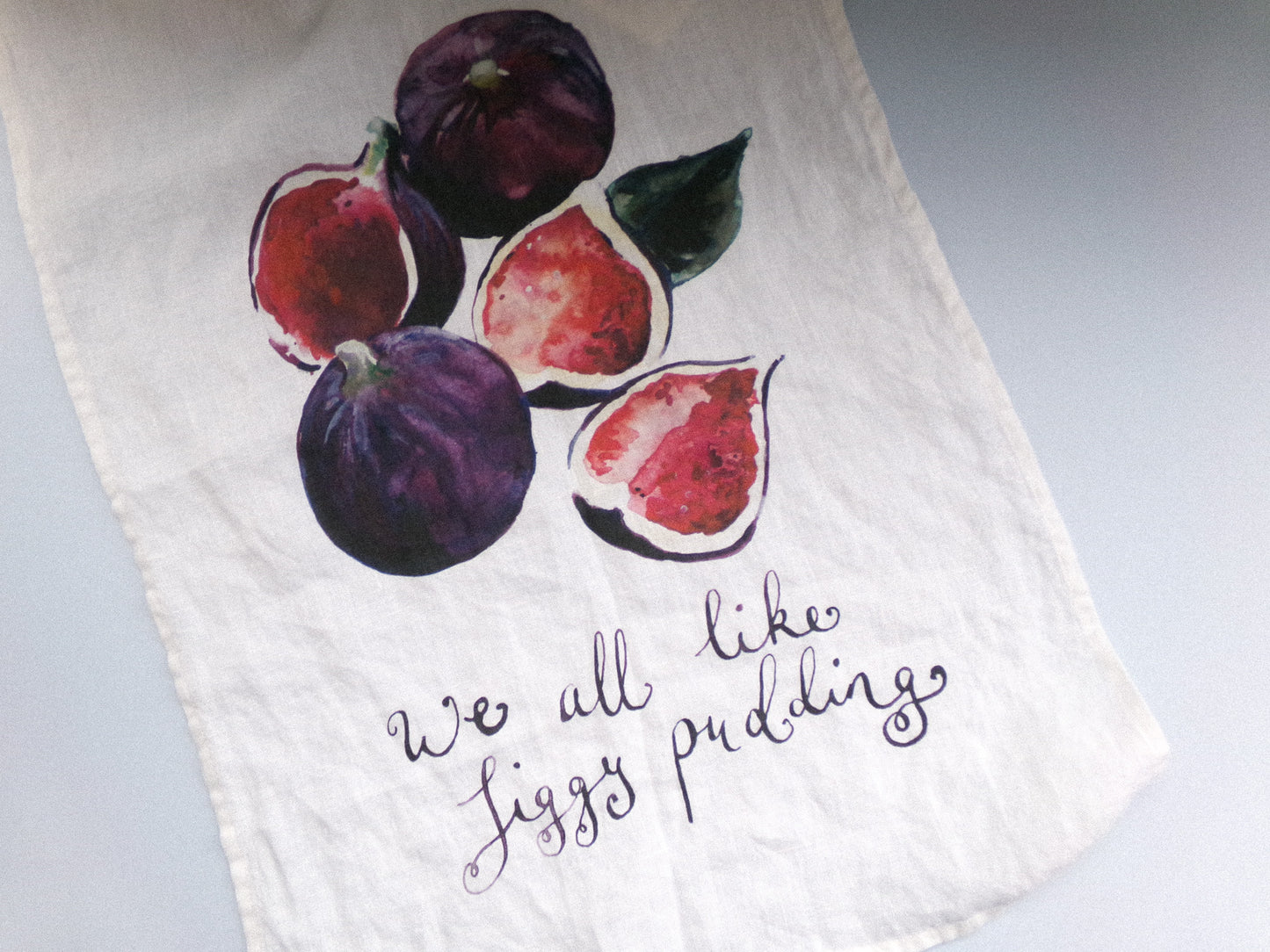 Towel with fig illustrations and text on a white background