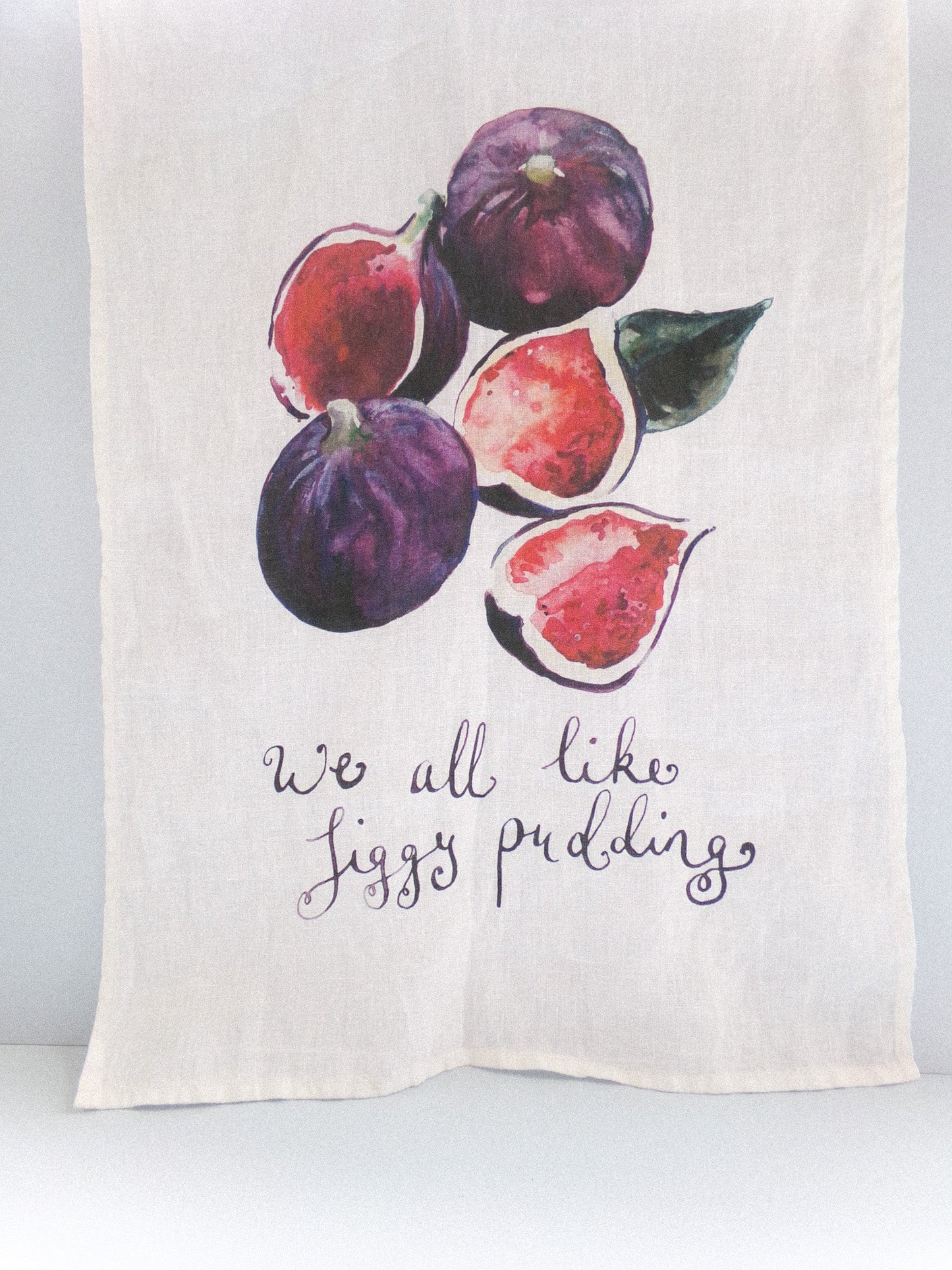 Towel with fig illustrations and text on a white background