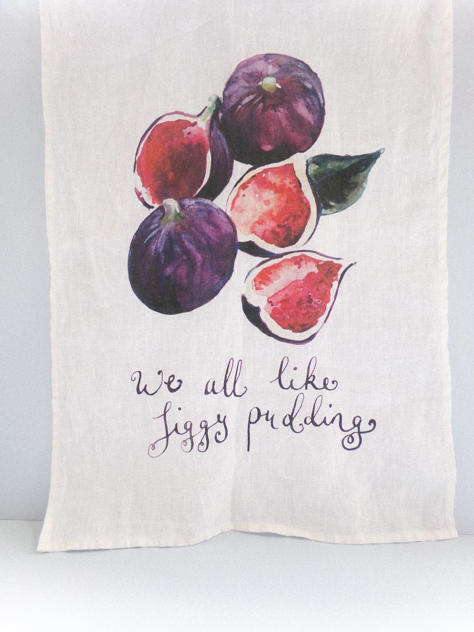 Towel with fig illustrations and text on a white background