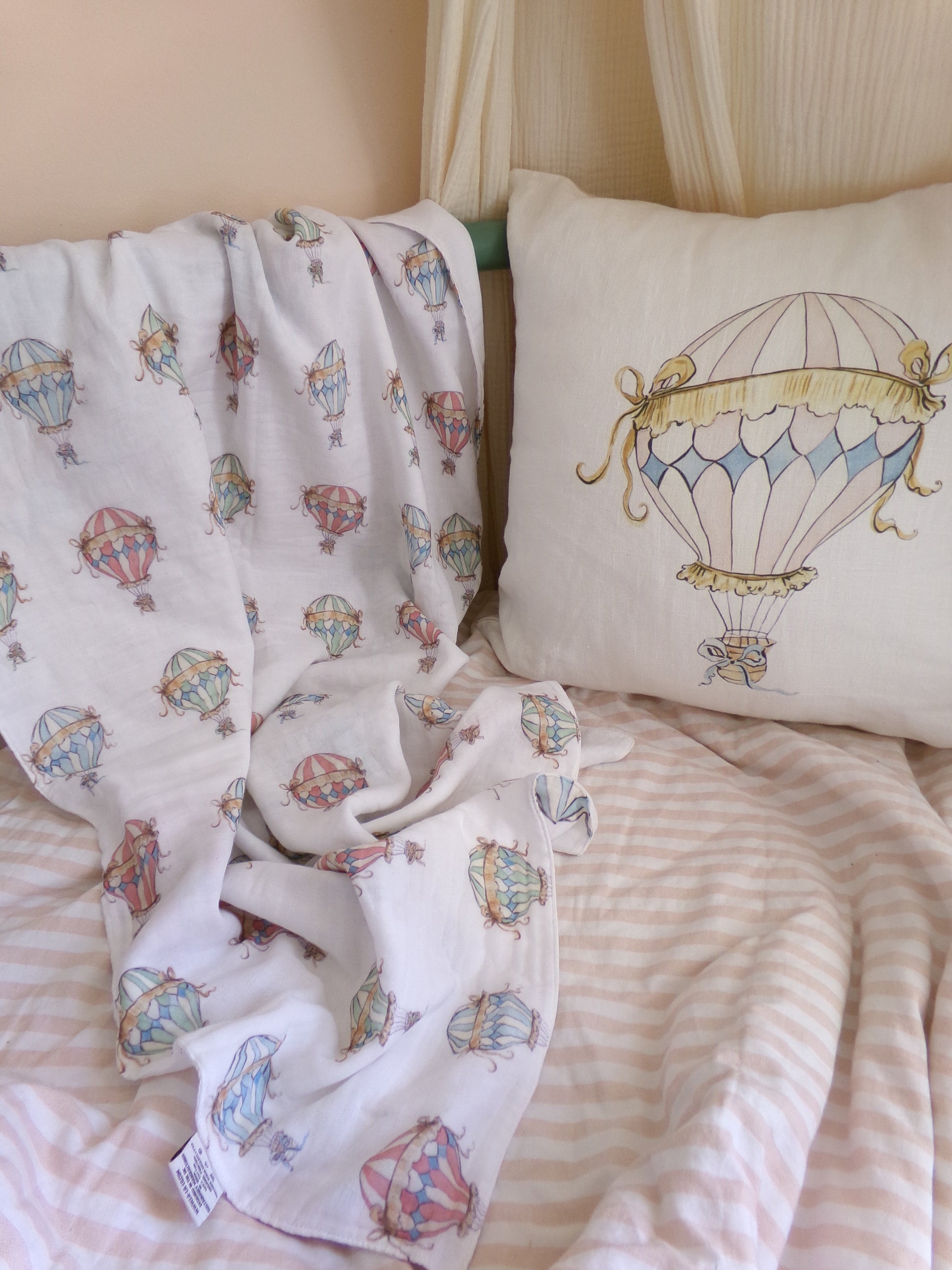 Bedding set with hot air balloon pattern on a pillow and blanket
