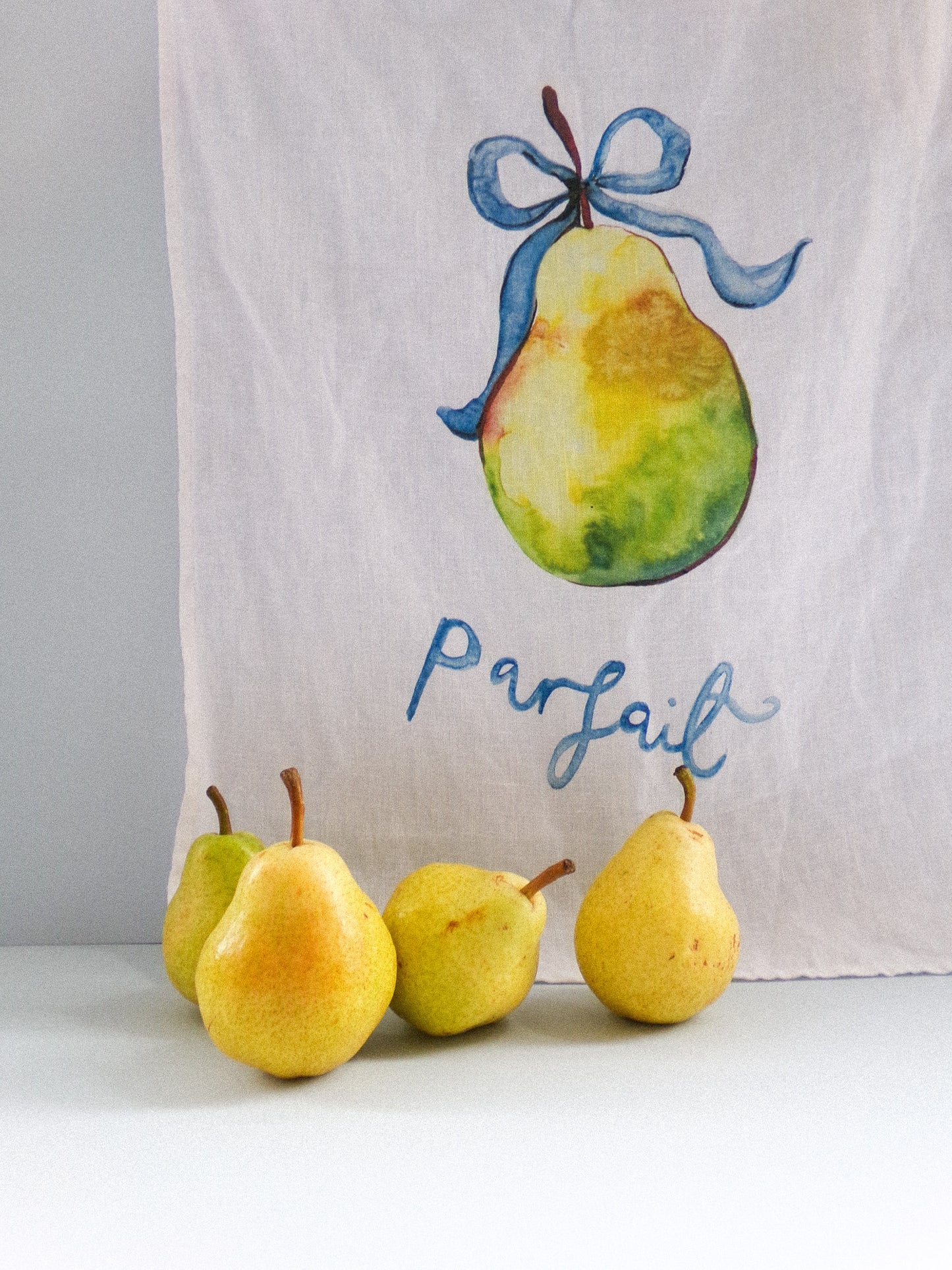 Towel with a pear design and the word 'Parfait' on a white background
