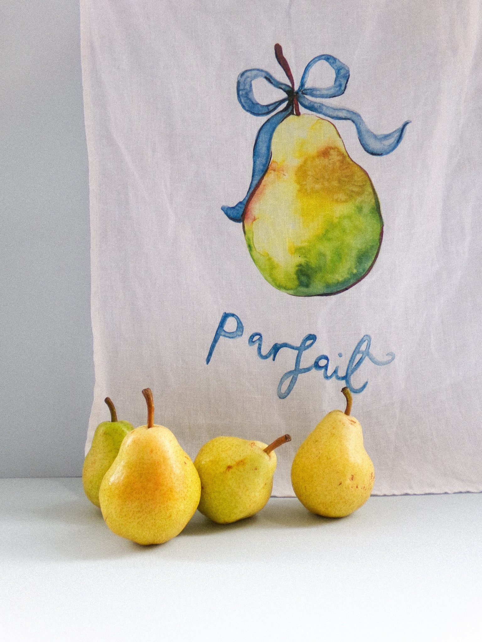 Towel with a pear design and the word 'Parfait' on a white background